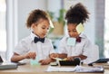 Children, together and playing office with sticky note at desk with happiness, brainstorming and teamwork. Kids, girl Royalty Free Stock Photo