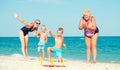 Children together with their mother and grandmother playing a game throwing rings on the beach Royalty Free Stock Photo