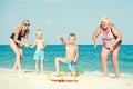 Children together with their mother and grandmother playing a game throwing rings on the beach Royalty Free Stock Photo