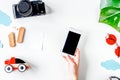 Children tourism outfit with camera and mobile on white background flat lay mockup