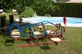 Children toy plane in home garden playground front swimming pool Royalty Free Stock Photo