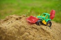 Children toy tractor in sandbox