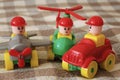 Children toys. Multi colored plastic constructor with blocks for building houses and cars, plain, bus with figures of people Royalty Free Stock Photo