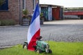 Children tractor and flags upside down in Lekkerkerk along the N210 in the municipality of Krimpenerwaard