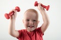 Children train with dumbbells. The concept of sport in the family