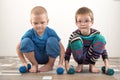 Children train with dumbbells. The concept of sport in the family