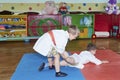 Children train grasps in judogi