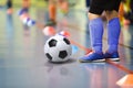 Children training soccer futsal indoor gym. Young boy with soccer ball