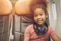 Children traveling alone or unaccompanied minor. child girl fly travel sitting alone in flight cabin seat happy smile