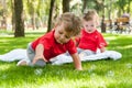 Children twins play on the grass
