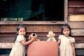 Children two cute asian little girls playing with doll Royalty Free Stock Photo