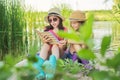 Children two girls resting playing reading their notebook in nature Royalty Free Stock Photo