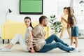 children tying parents with rope on floor at home