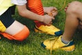 Children tying shoe laces. Kids on sports football team tying soccer cleats Royalty Free Stock Photo