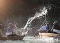 Children under the spray of water in the floating boats