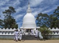 Children in uniform on the stairs at white buddhist stupa building located in Nuwara Eliya town