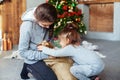 Children unpack dog gift for Christmas. Royalty Free Stock Photo