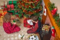 Children unwrapping Christmas presents.