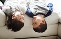 Children upside down, play and happy at family home, fun with sibling and face of brothers on sofa and relax in living Royalty Free Stock Photo