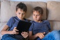 Children using digital tablet computer at home. Technology, online learning, distance education, educational games for Royalty Free Stock Photo