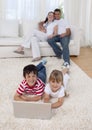 Children using a laptop on floor in living-room Royalty Free Stock Photo