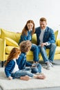 Children using laptop while parents sitting Royalty Free Stock Photo