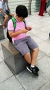 Children Using Mobile phone in front of Marina Bay Sands and cityscape