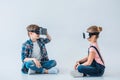 Children using virtual reality headsets while sitting on the floor Royalty Free Stock Photo