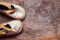 Children vintage shoes on old wood background