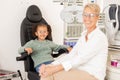 Children, vision and glasses with a girl customer and optometrist consulting in an office for an eye test. Portrait