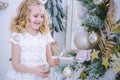 Children Waiting for the New Year.Cute little girl decorating Christmas tree. Royalty Free Stock Photo