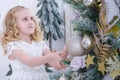 Children Waiting for the New Year. Cute little girl decorating christmas tree. Royalty Free Stock Photo