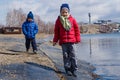 Children walk along the lake shore in the spring Royalty Free Stock Photo