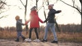 children walk in the forest in autumn park. happy family kid dream concept. a group of children holding hands in jackets Royalty Free Stock Photo