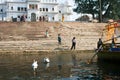 Children walk on the old stairs of the ghat