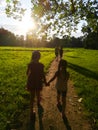 Children on a walk in the park at sunset