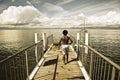 Children walking along a small jetty in Lake Leman Royalty Free Stock Photo