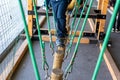 Children walking on trunks suspended by ropes in an adventure park Royalty Free Stock Photo