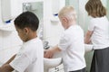 Children washing their hands in a school bathroom