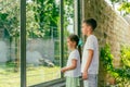 Children watch the animals in the zoo through a protective glass fence