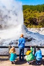 ROTORUA, NEW ZEALAND - OCTOBER 10, 2018: Children watch the eruption of Lady Knox geyser in Wai-O-Tapu. Vertical