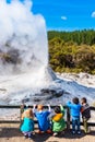 ROTORUA, NEW ZEALAND - OCTOBER 10, 2018: Children watch the eruption of Lady Knox geyser in Wai-O-Tapu. Vertical