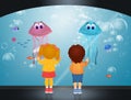 Children watch the jellyfish in the aquarium