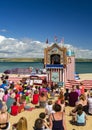 Children watch a Punch and Judy show of a Dorset beach