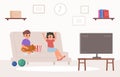 Children watching tv in living room. Cute cartoon boy and girl with cat and popcorn on sofa. Funny little sister and Royalty Free Stock Photo