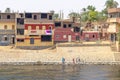 Aswan, Egypt - September 13, 2018: Children waving to Nile Cruise tourists next to the Nile River, southern Egypt
