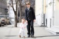 Children wearing formal clothes on sunny street