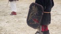 Children wearing historic suits reenacting knights' tournament at theme camp