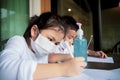 Children wearing protection mask with alcohol gel on working table study in home living room Royalty Free Stock Photo