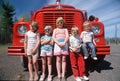 Children wearing sunglasses with a fire truck